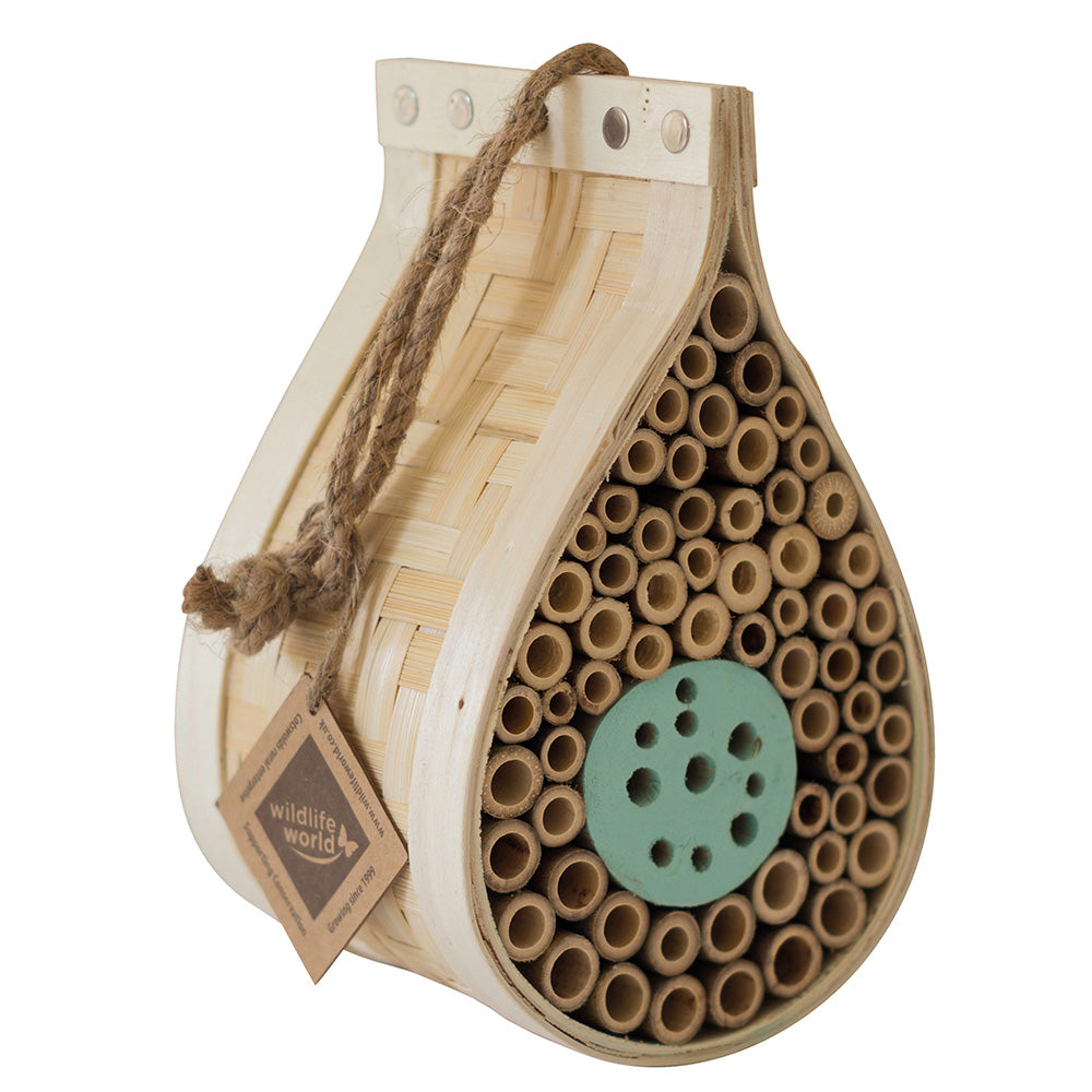 Dewdrop Bee and Bug Hotel on white background. Featuring a woven wood exterior and the inside of the dewdrop filled with small wooden tubes. Natural rope hanger and rustic apperance. 