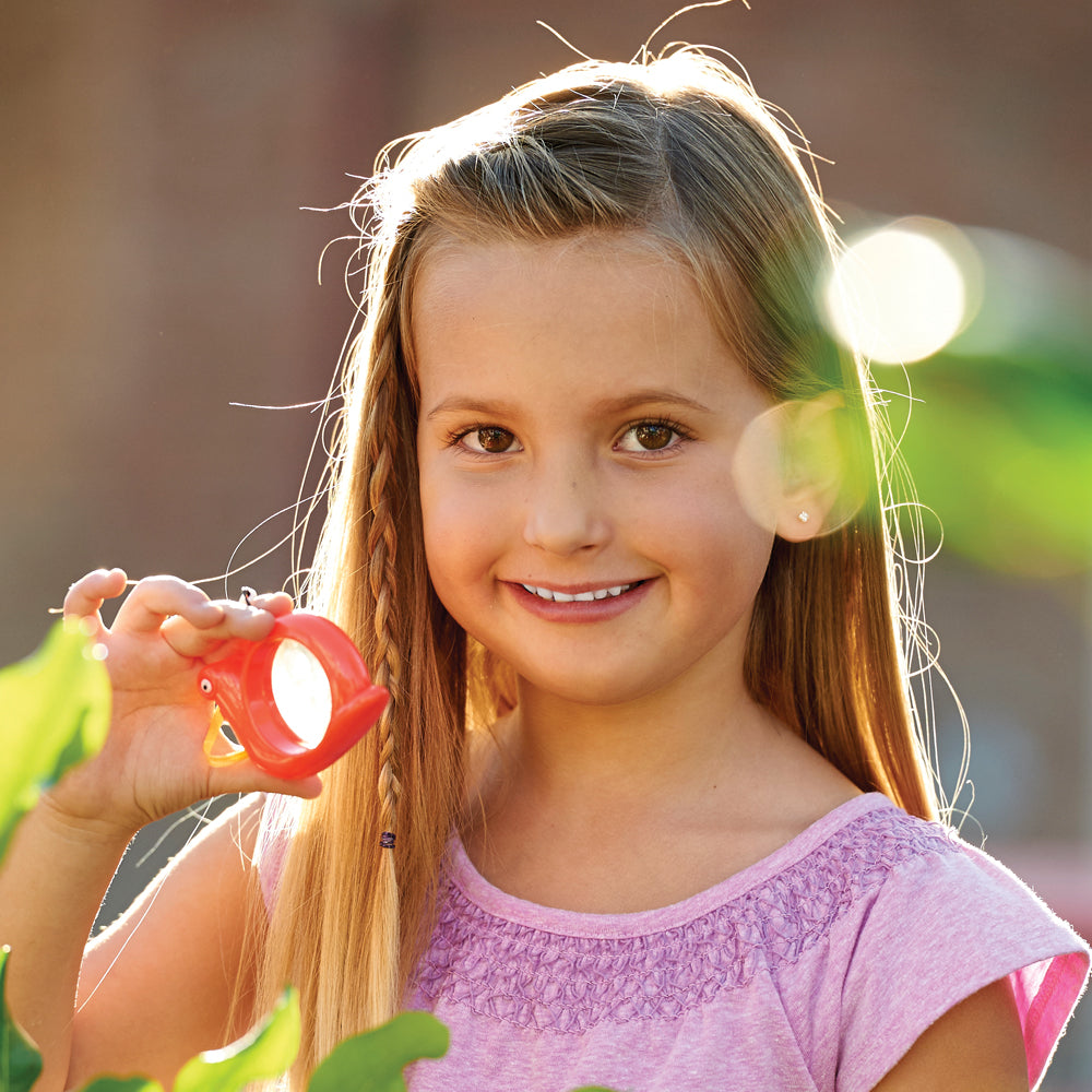 Young girl holding the Red Butterfly Mini Magnifier.