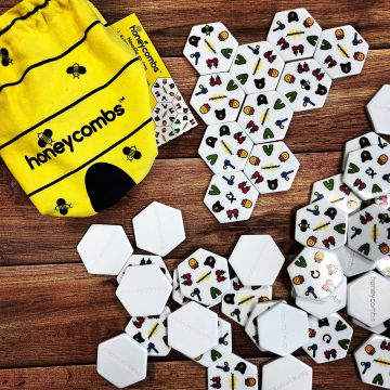 Honeycombs Game. Yellow Bag emptied with ceramic playing pieces showing how to play.
